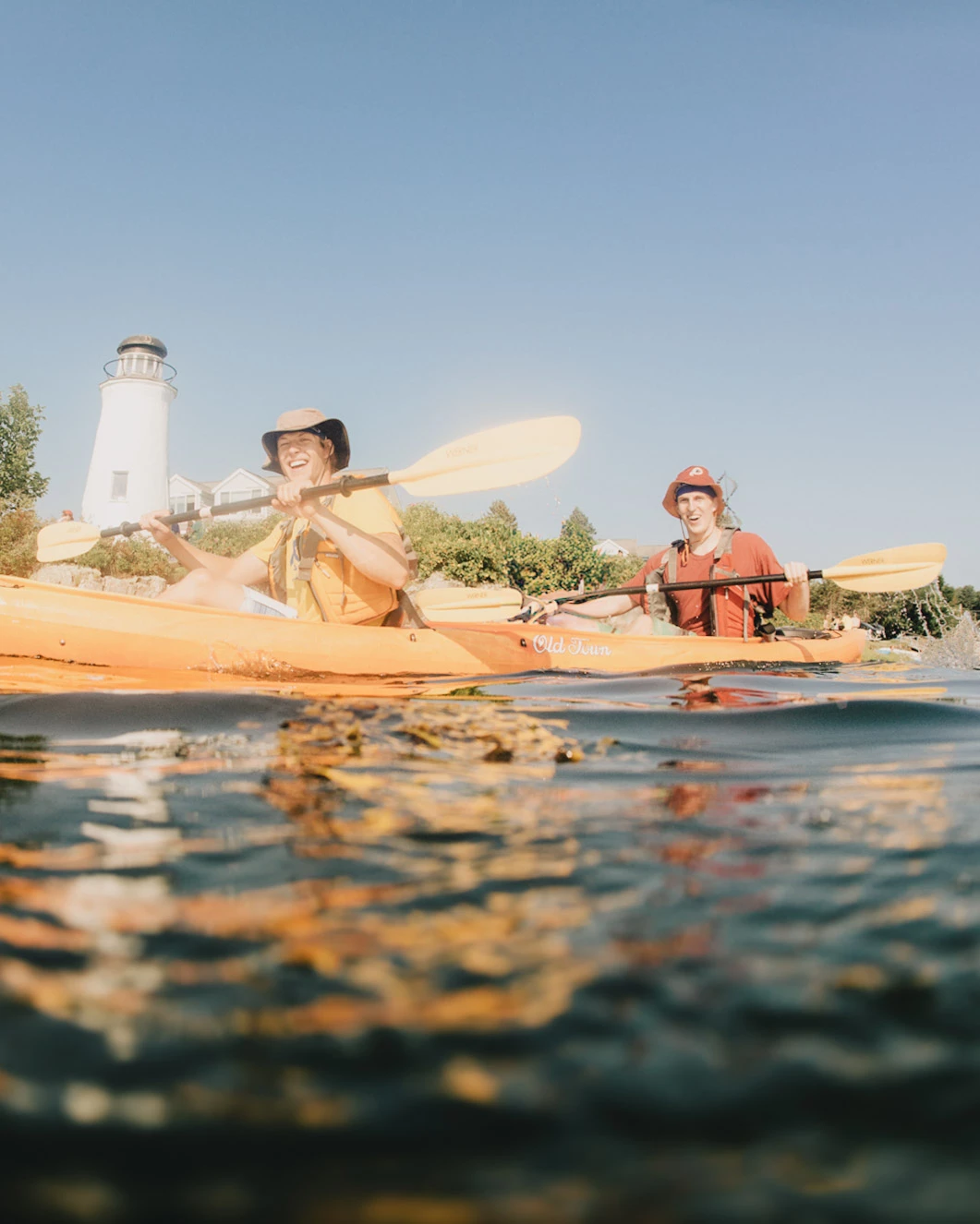 a couple of people in kayaks on the water