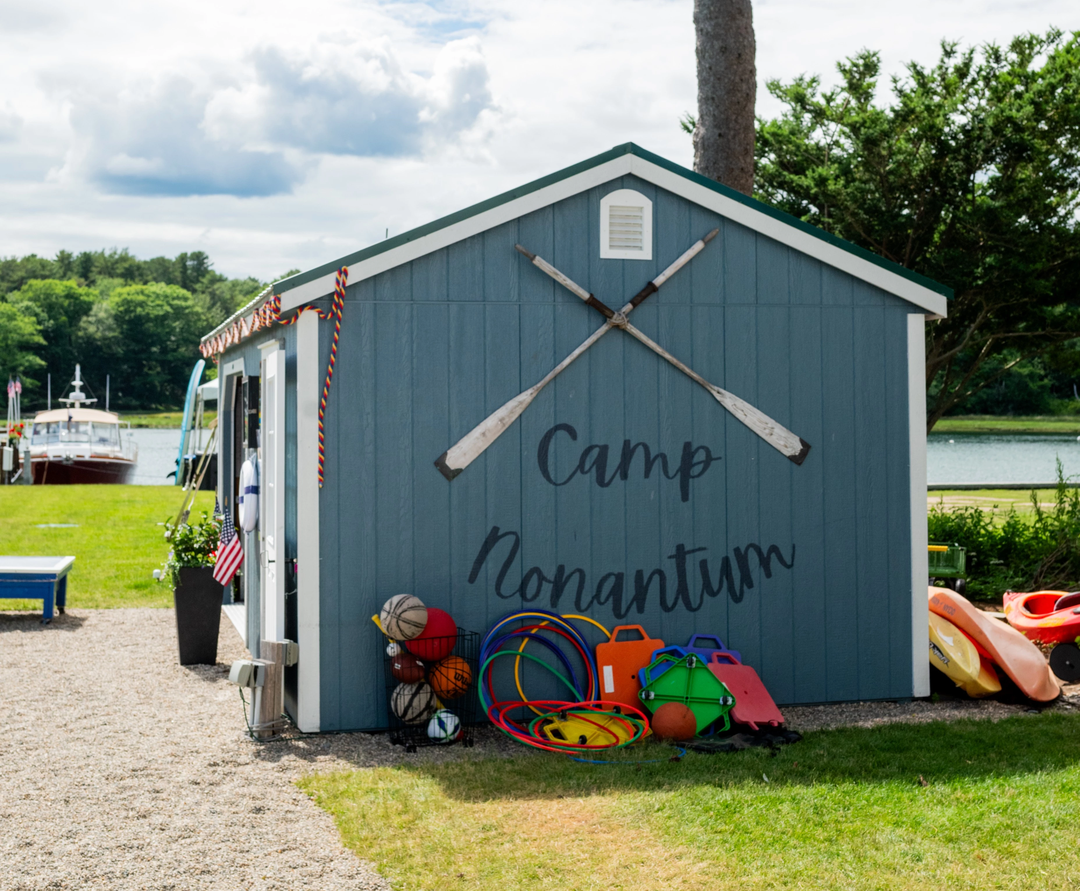 a blue shed with paddles and toys on the side