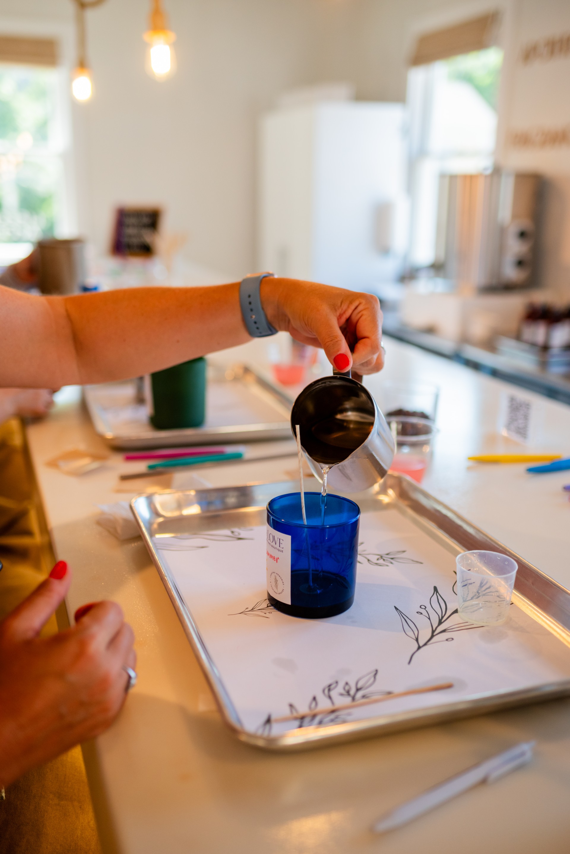 a person pouring liquid into a cup