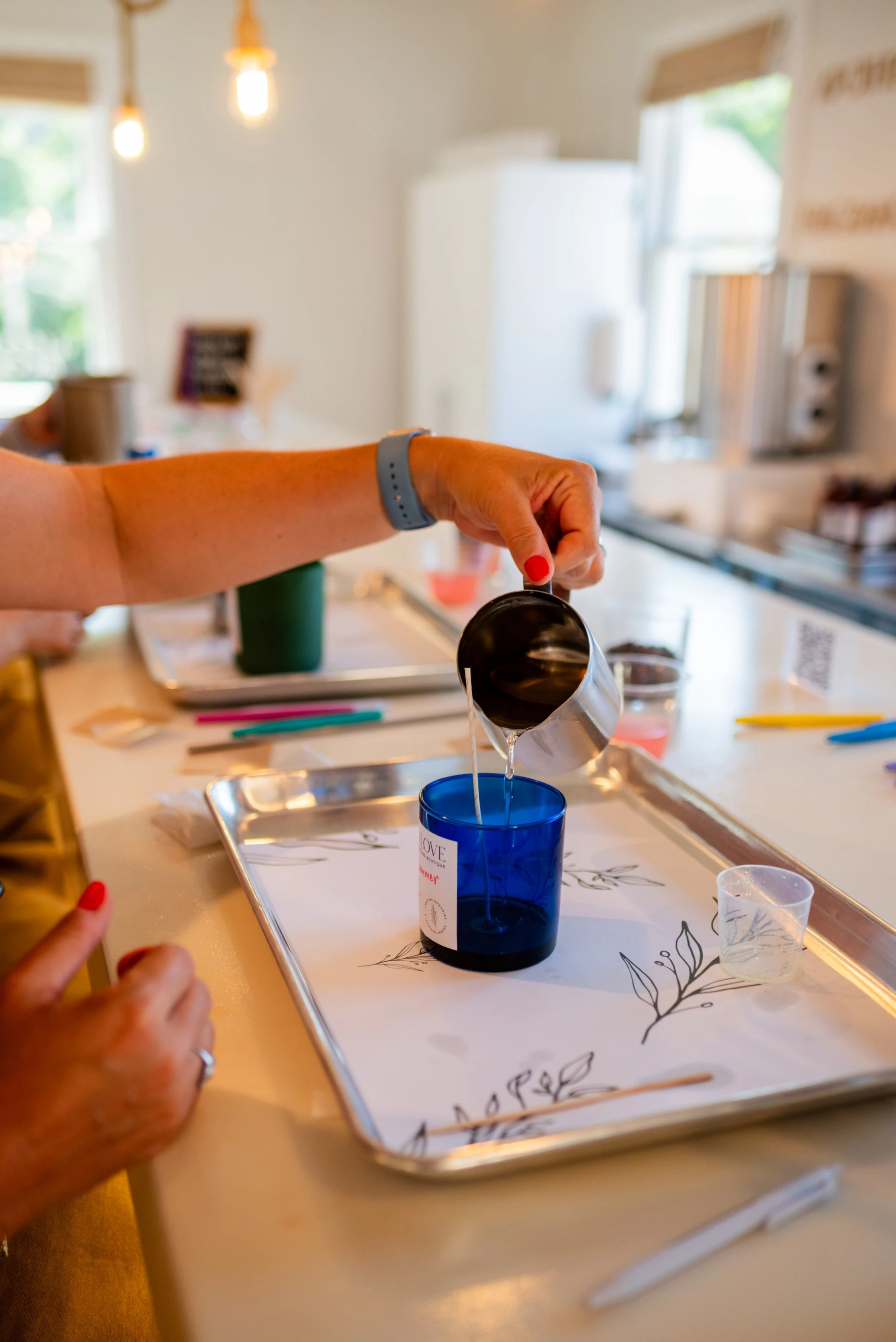 a person pouring liquid into a cup