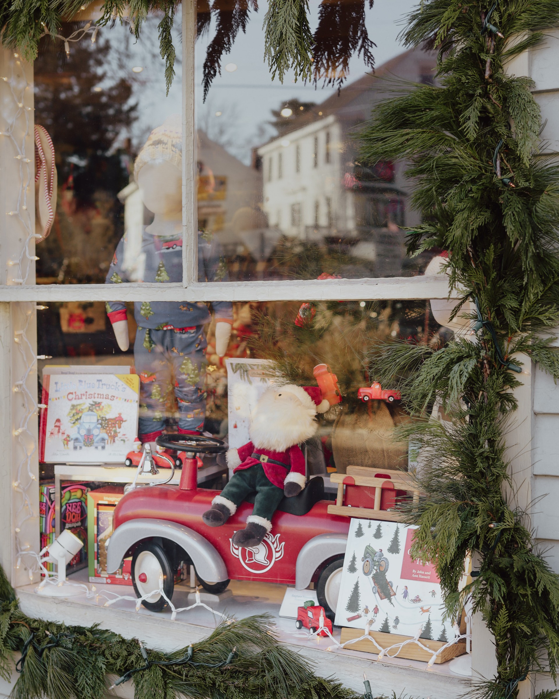 a window with a toy car and a garland