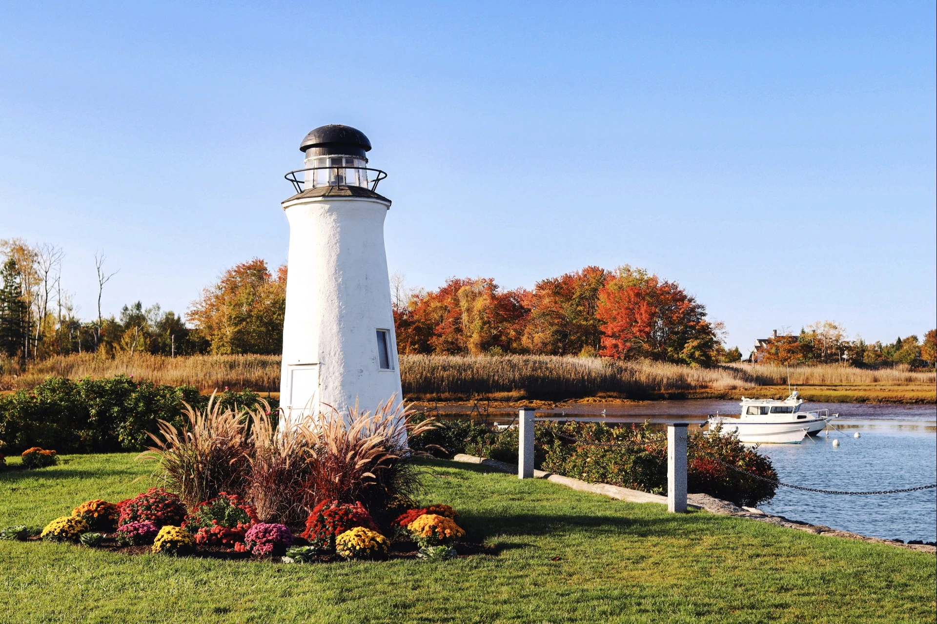 a lighthouse with a boat in the background