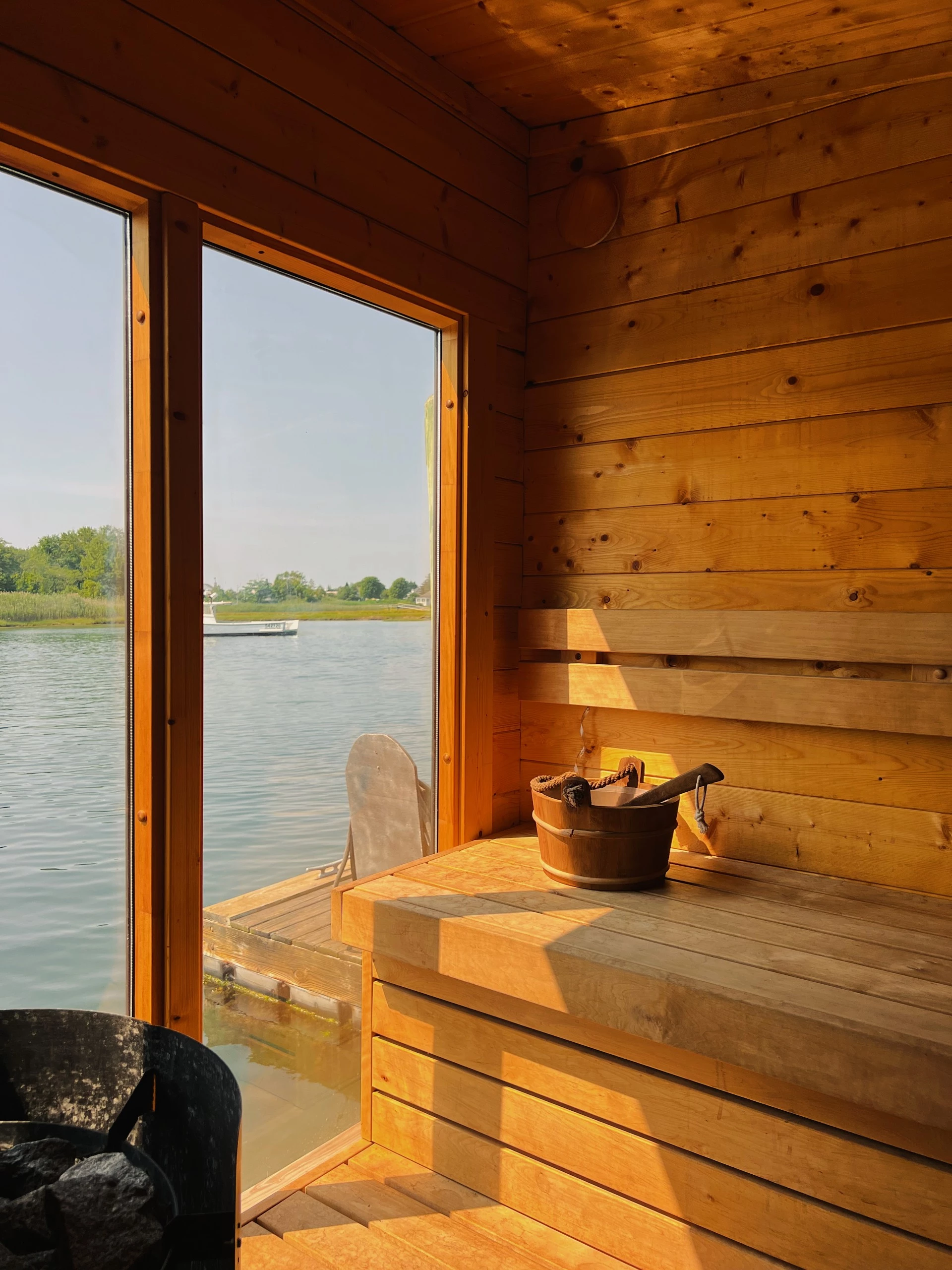 a wooden room with a bucket and a wooden tub