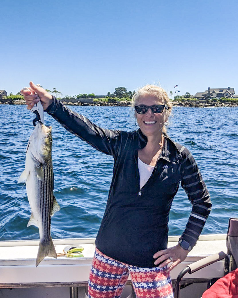 a woman holding a fish