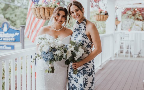 two women in dresses posing for a picture