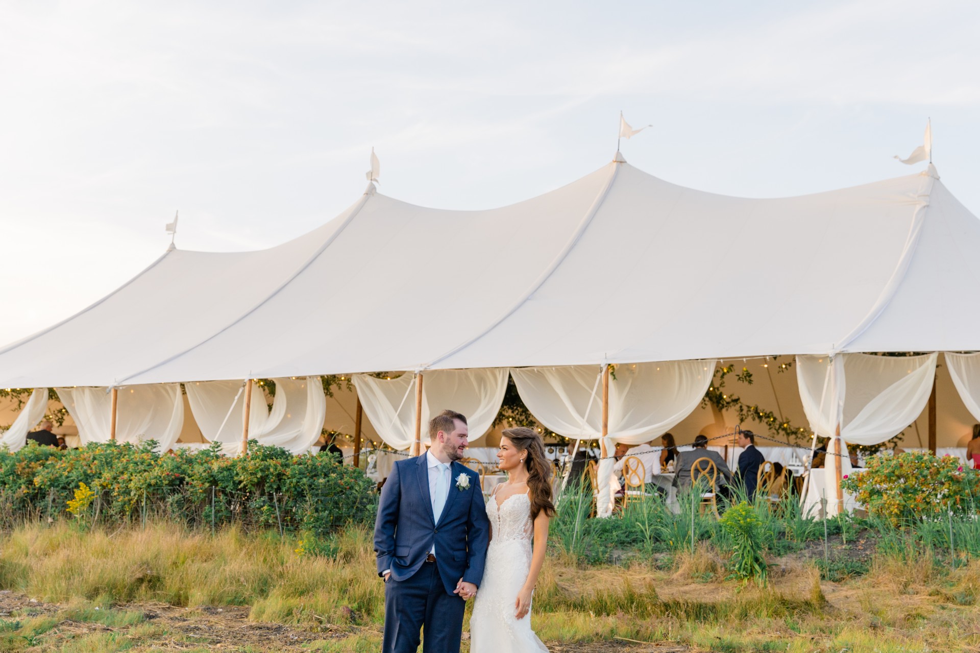 a man and woman standing in front of a tent