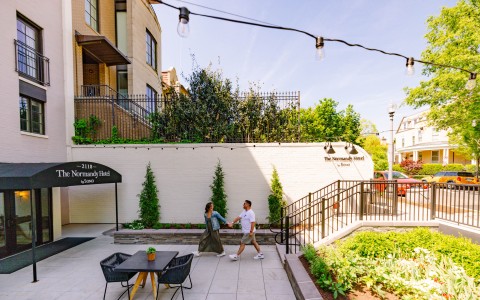 a man and woman walking on a sidewalk