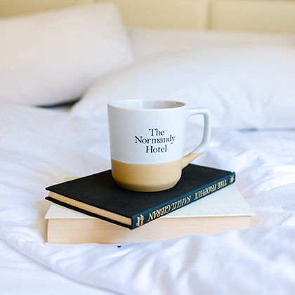 a coffee cup on top of a stack of books