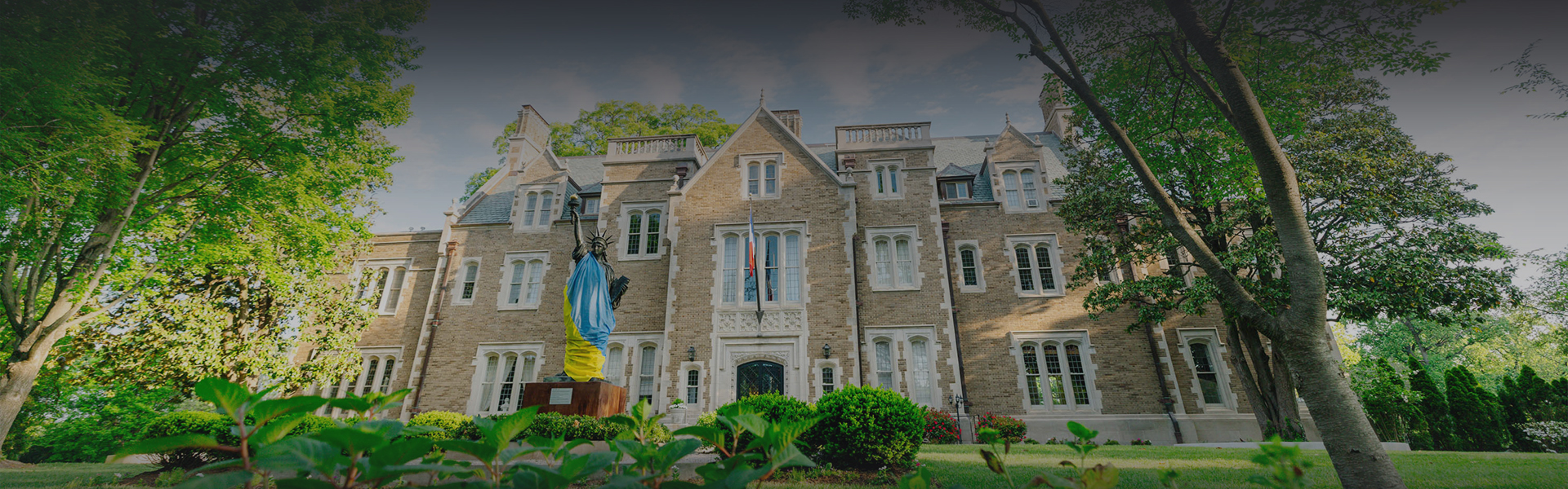 a statue in front of a large brick building