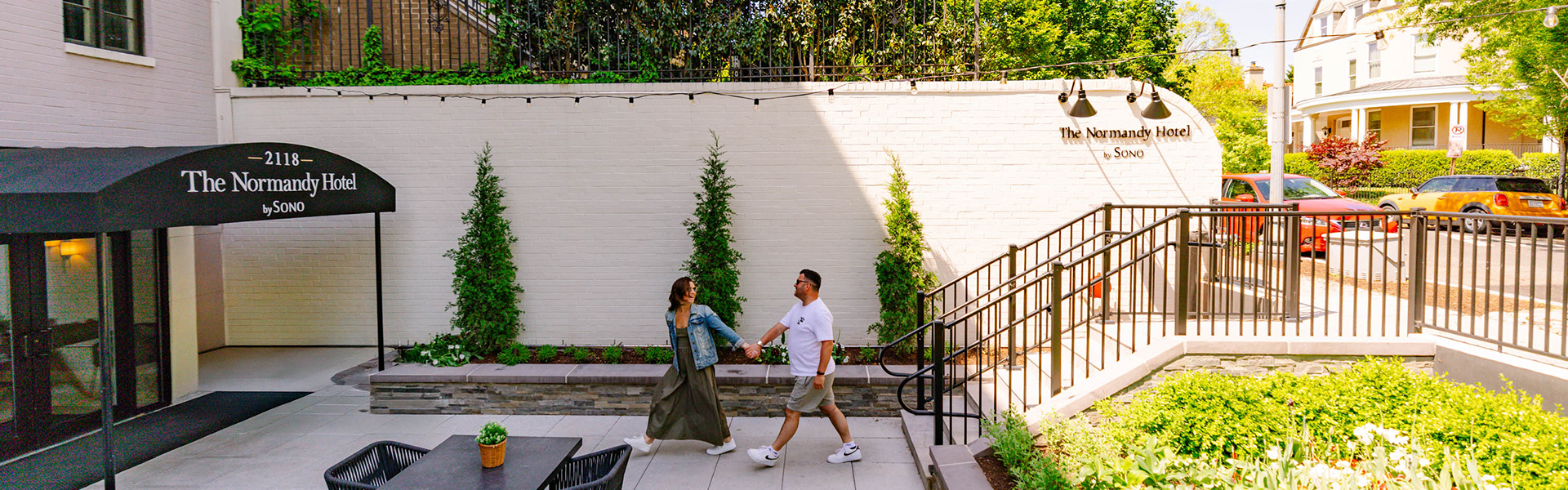 a man and woman holding hands and walking down stairs