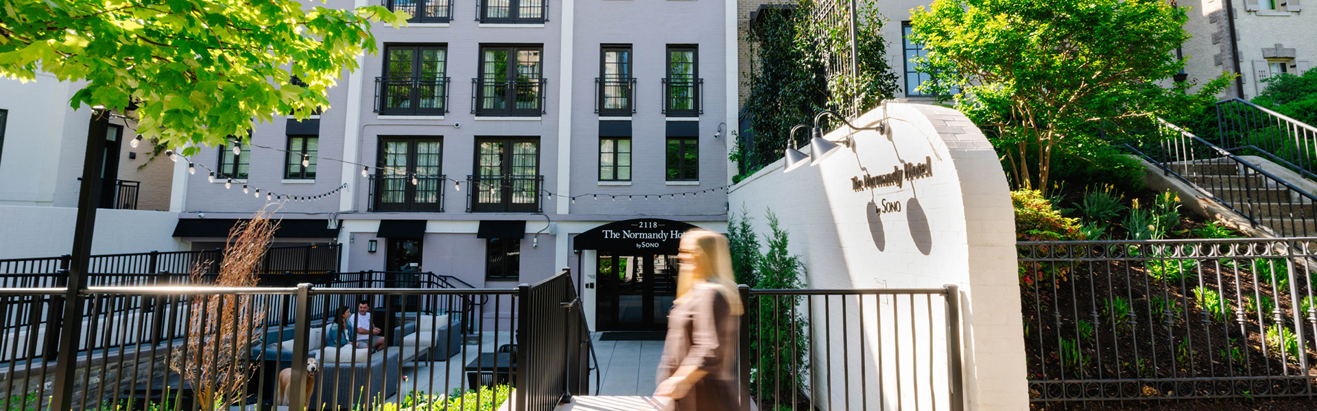 a woman walking down a stairs in front of a building