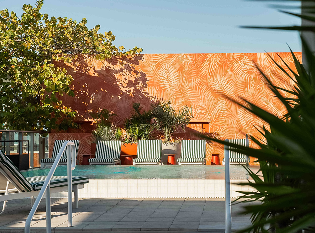 a pool with chairs and trees