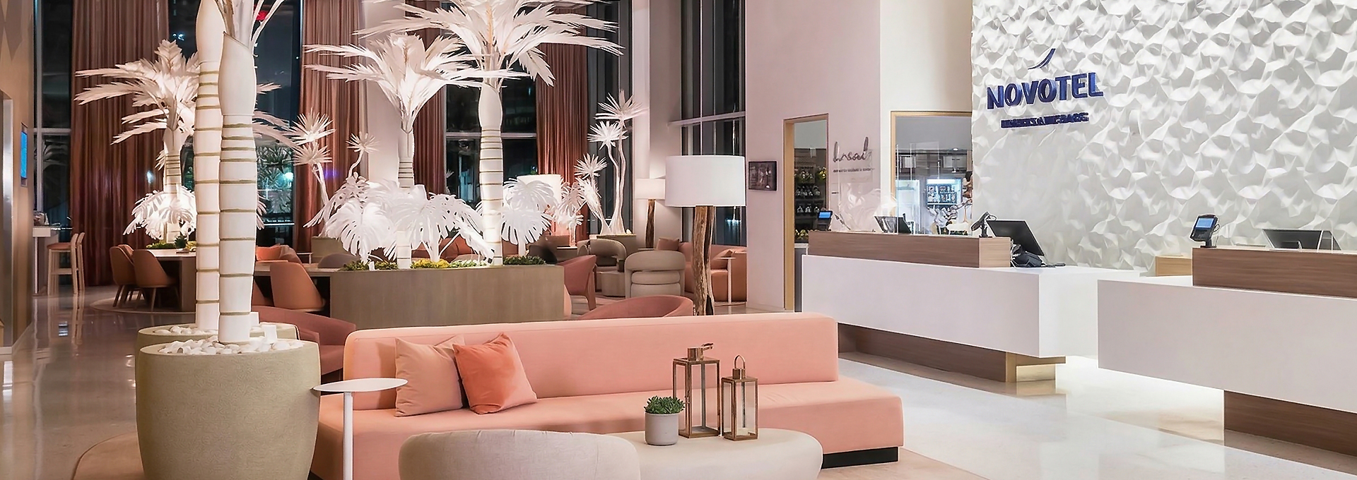 a room with a pink couch and a white table