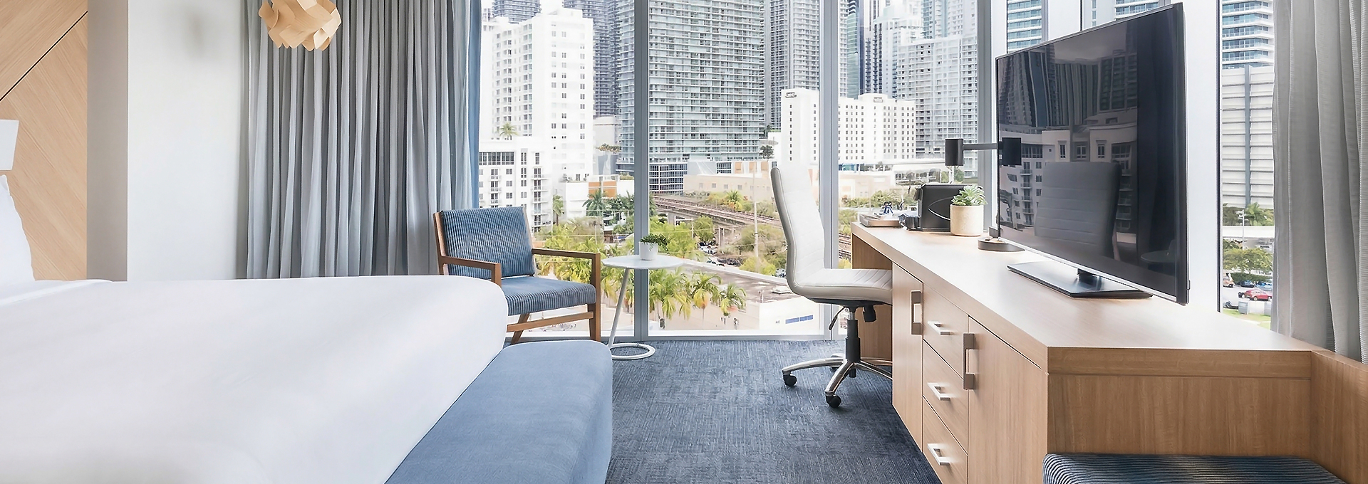 a room with a window and a couch and a desk