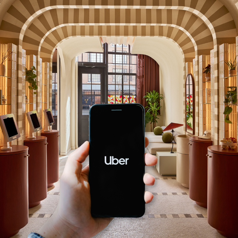a hand holding a phone in a room with a group of objects