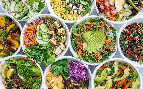 a collection of bowls of salad