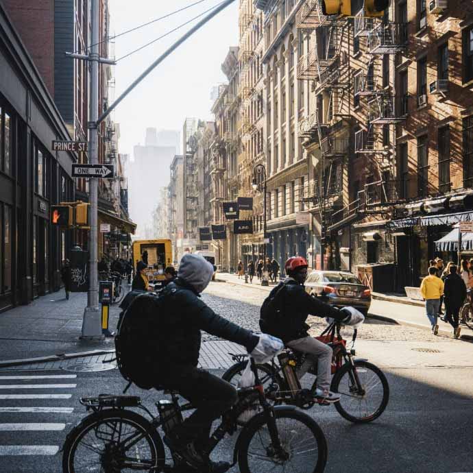 people riding bicycles on a street