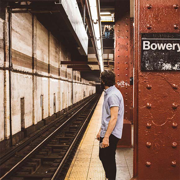 a man standing on a platform next to a train track