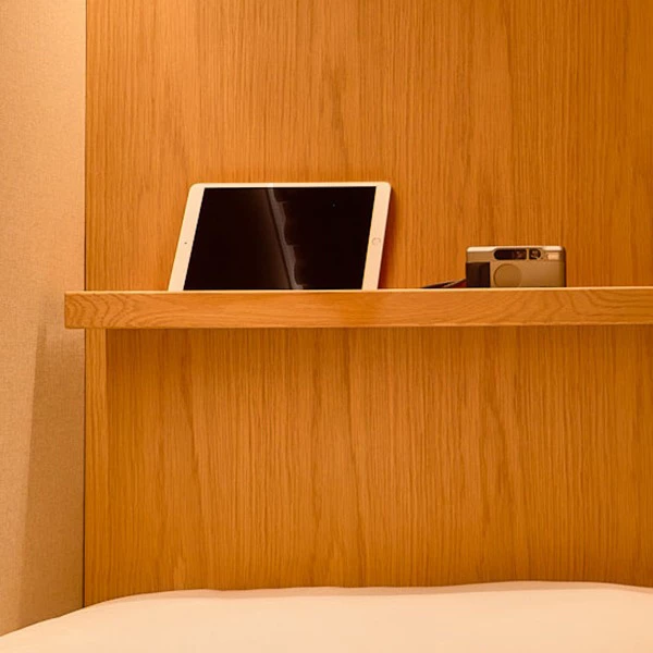 a tablet and camera on a wooden shelf