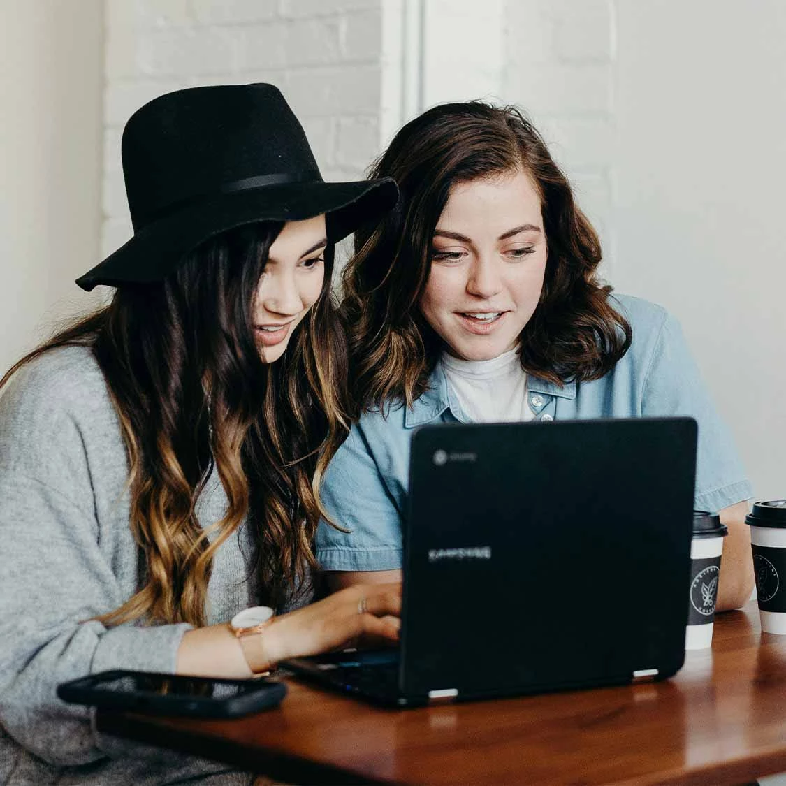 two women looking at a laptop