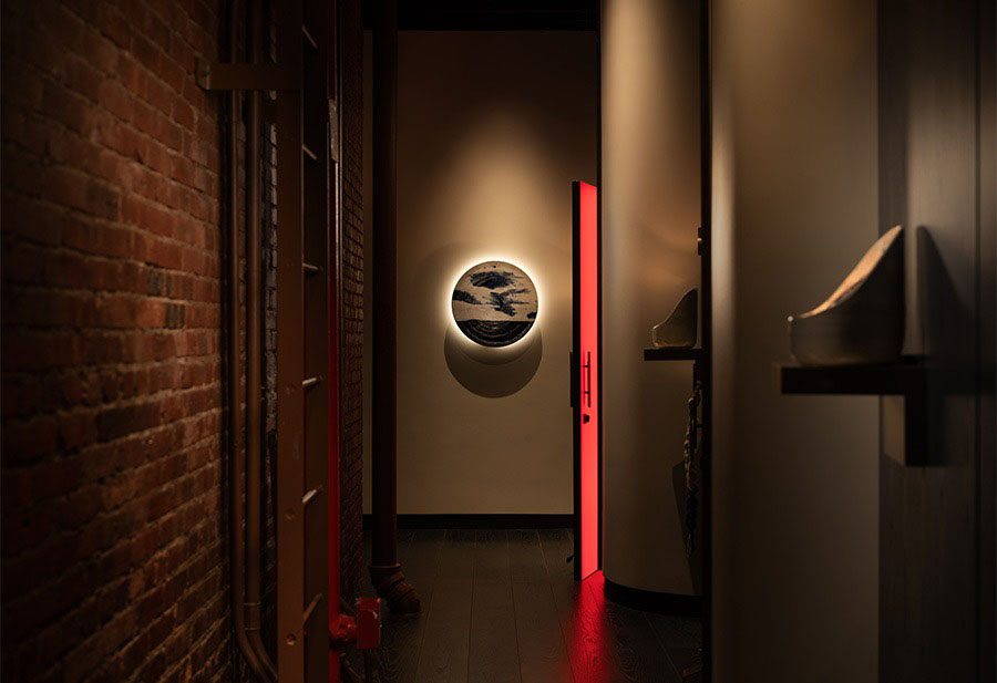 a hallway with a round light on the wall