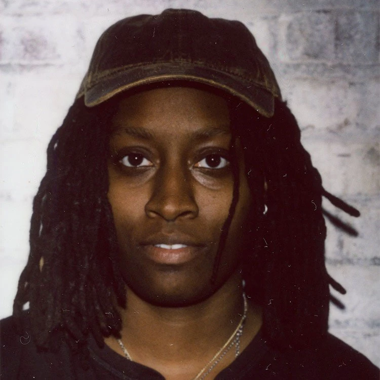a man with dreadlocks wearing a hat