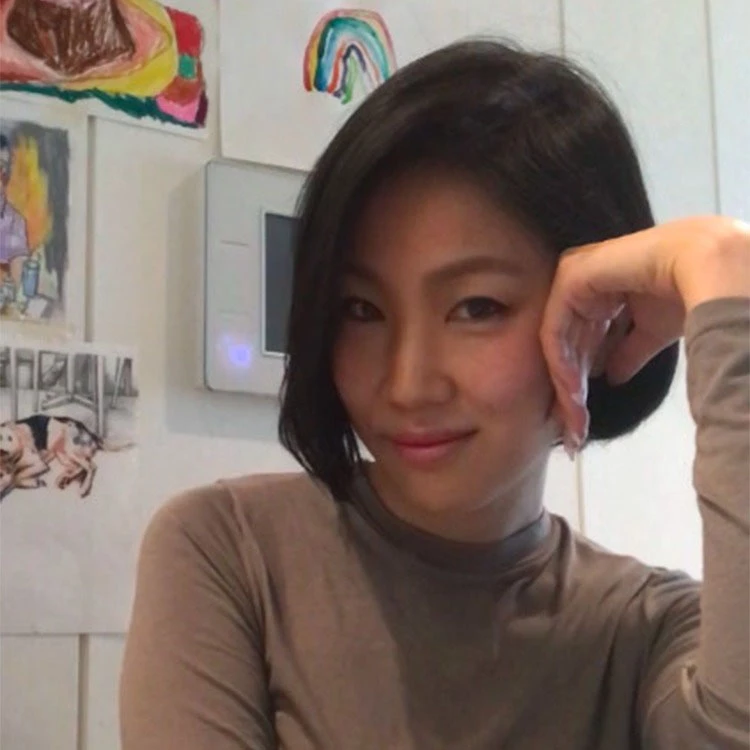 a woman with her hand on her face