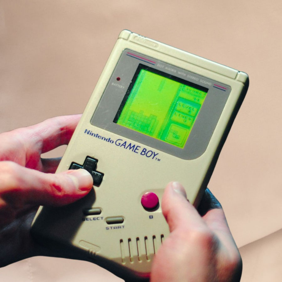 a hand holding a handheld game console