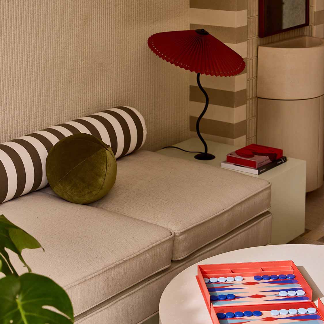 a room with a couch and a table with a game board