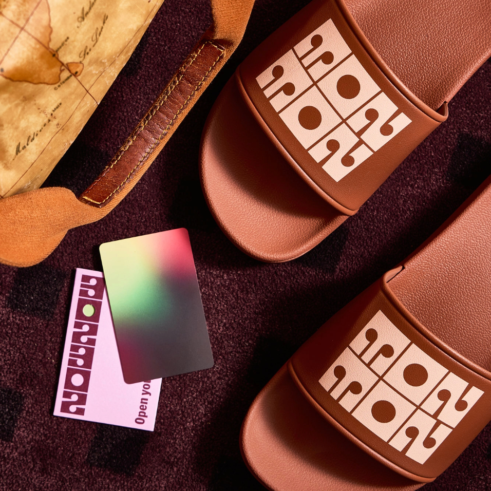 a pair of brown sandals with a map and credit card