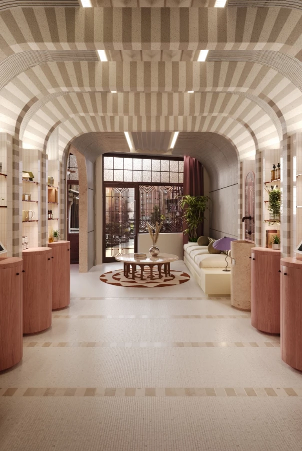 A wide lobby with a high, arched ceiling and a large window