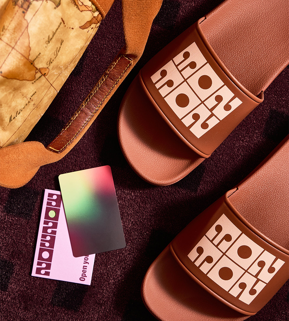 a pair of brown sandals with a map and credit card