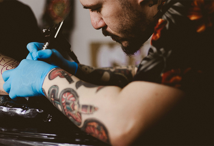a man with tattoos on his arm