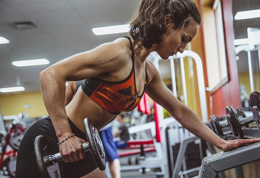 a woman lifting weights in a gym