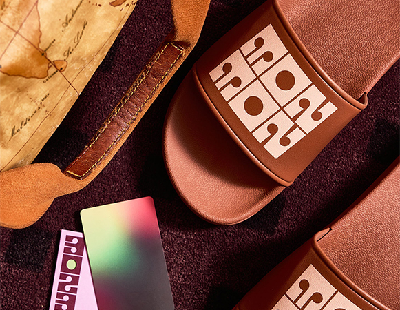 a pair of brown sandals with a map and a credit card