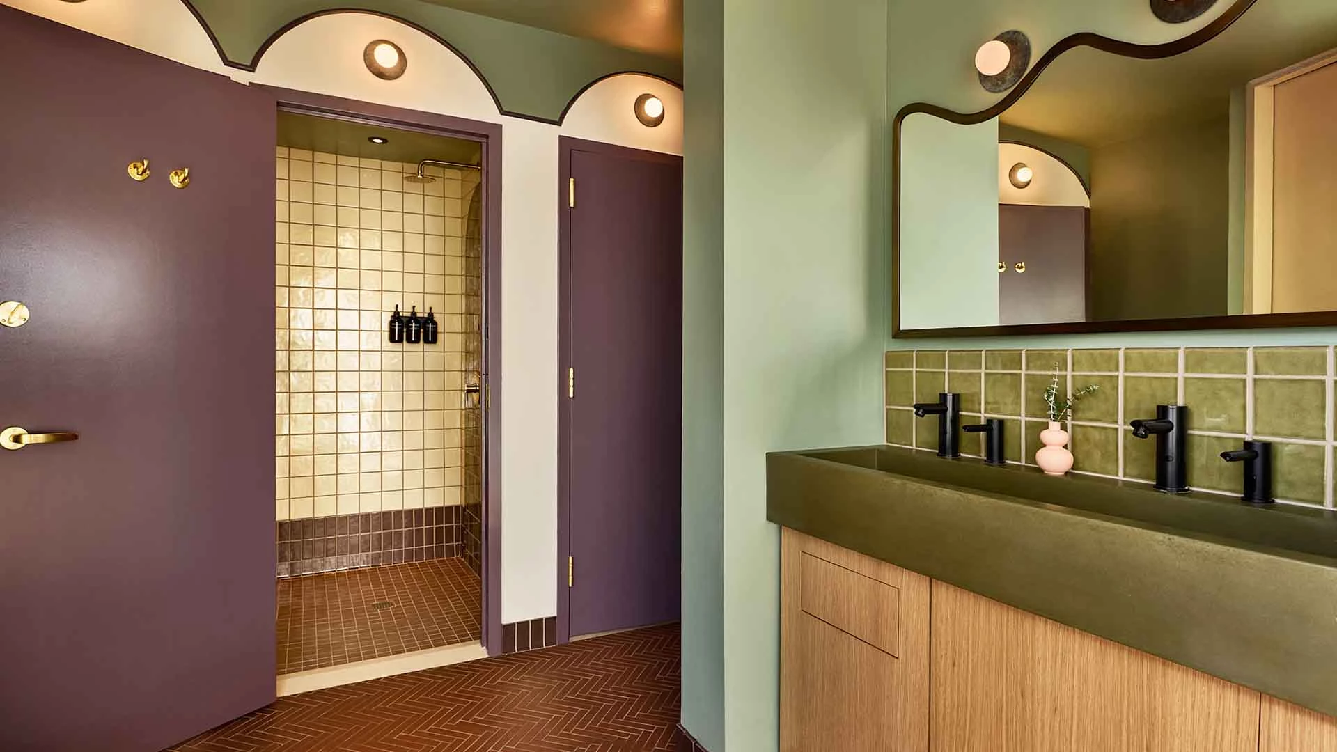 A bathroom with a green countertop, wooden cabinets, and a mirror