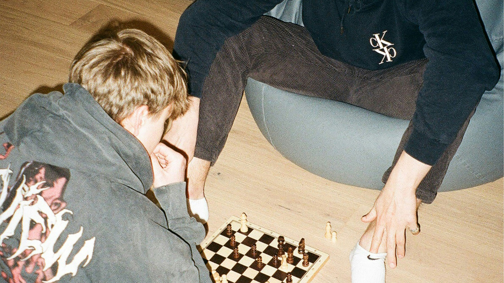 two men playing chess on the floor