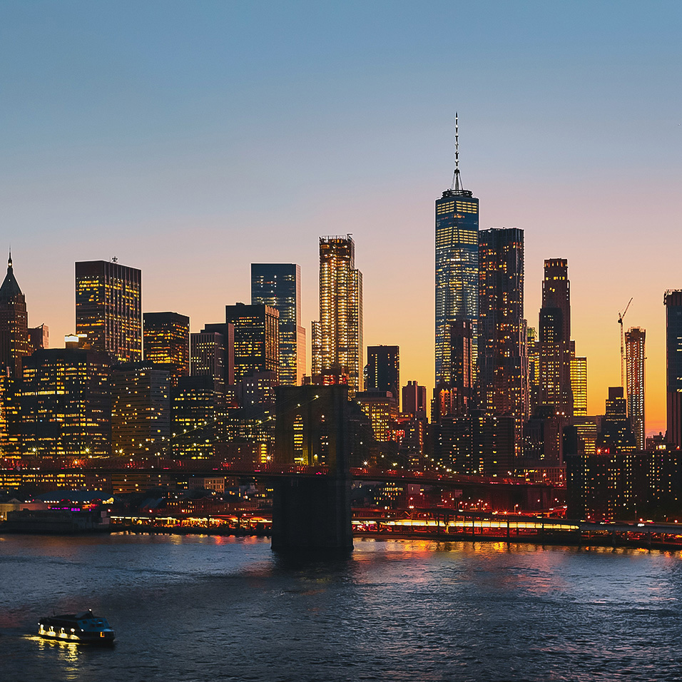 a city skyline with a bridge and a body of water