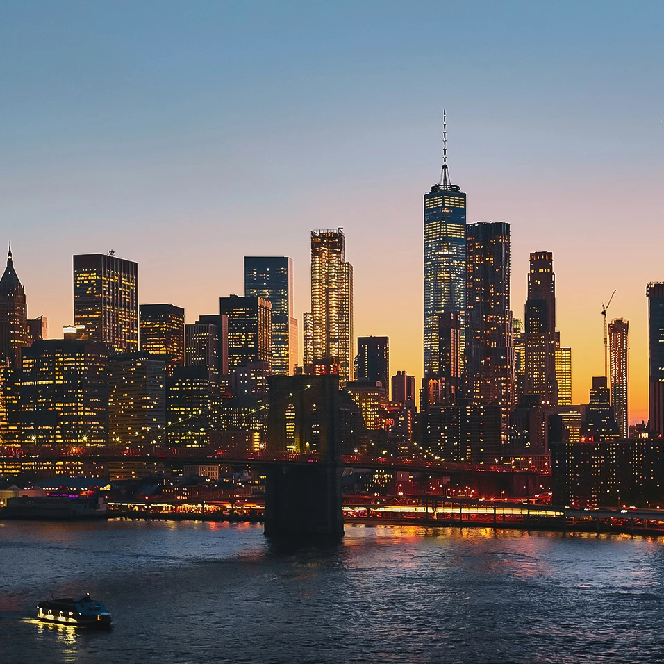 a city skyline with a bridge and a body of water