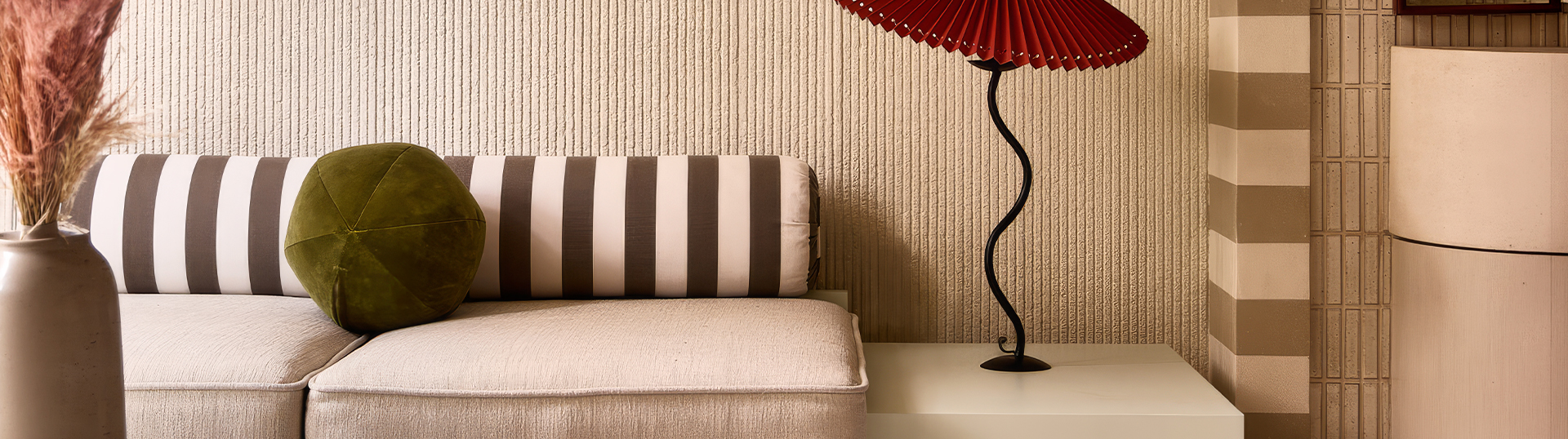 a lamp next to a couch
