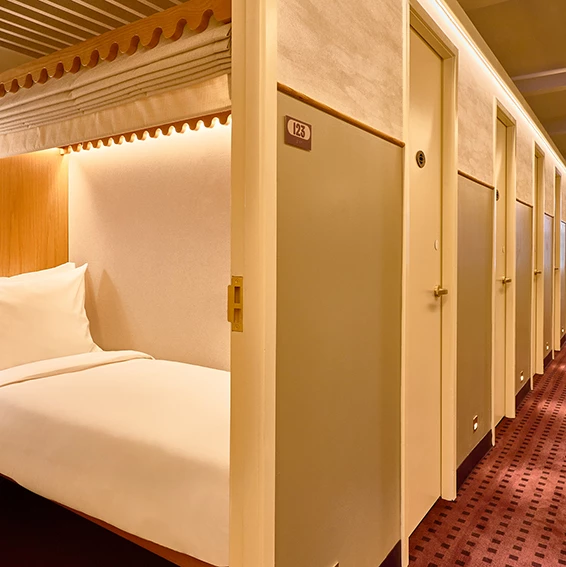 A hotel room with a bed and a door
