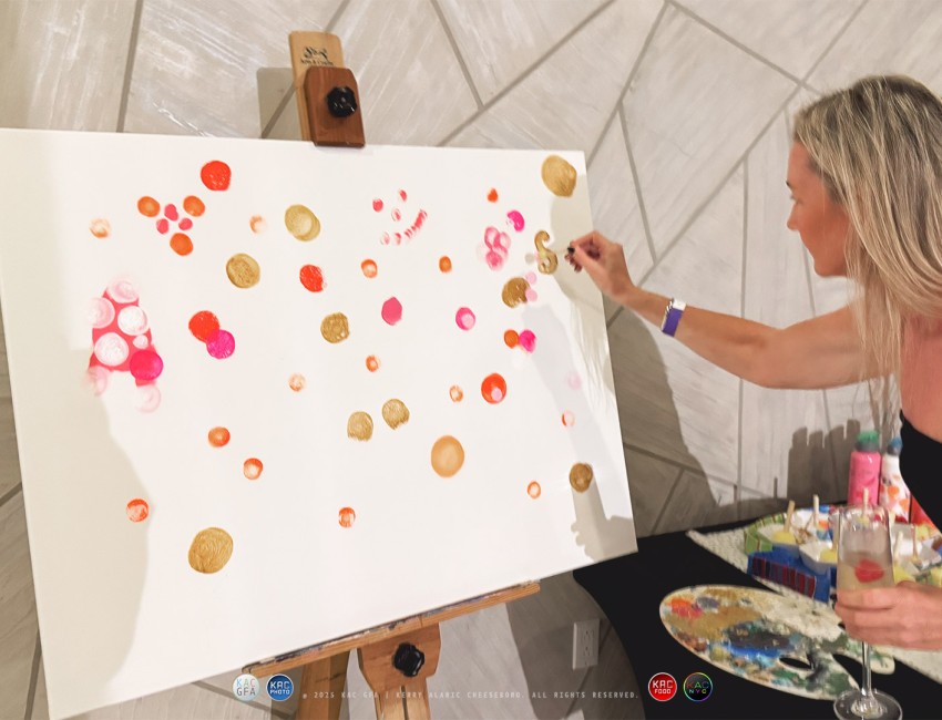a woman painting on a canvas