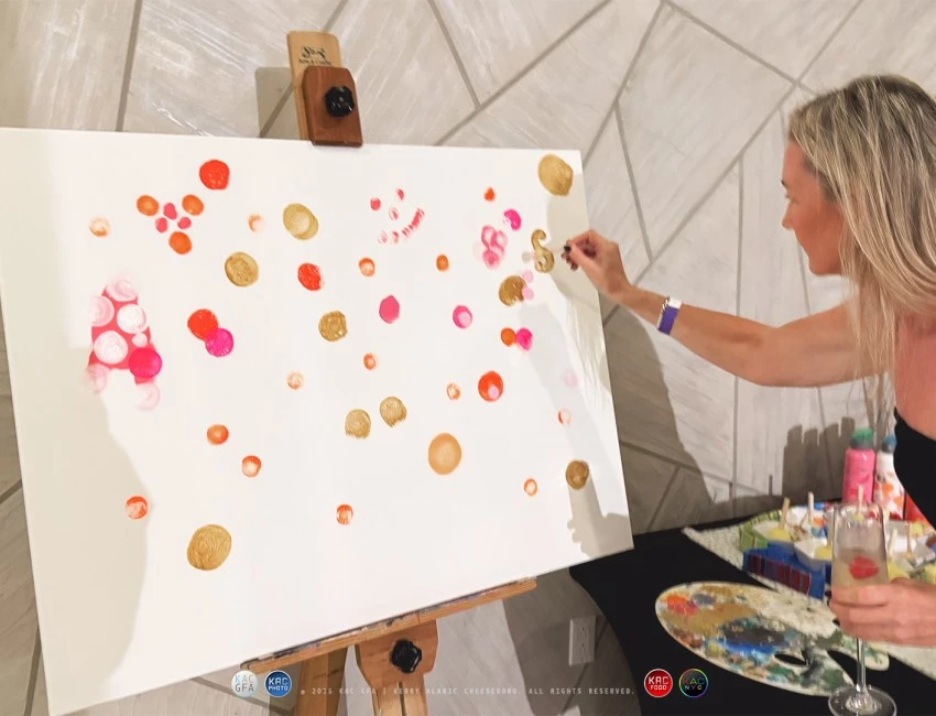a woman painting on a canvas