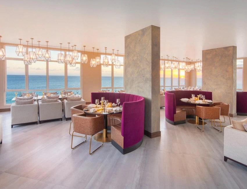 Beautiful dining room with purple booths over looking the ocean 