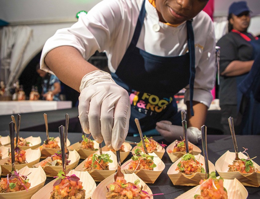 a female chef plating sample dishes