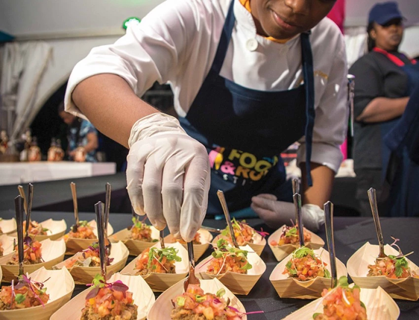 a female chef plating sample dishes