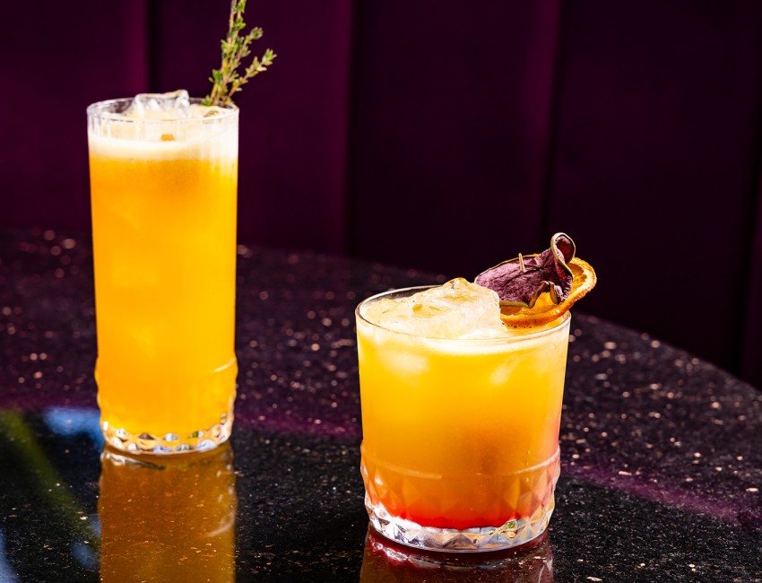 two glasses of orange and yellow drinks