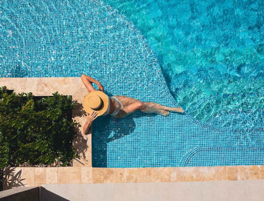 aerial shot of woman lounging in the pool