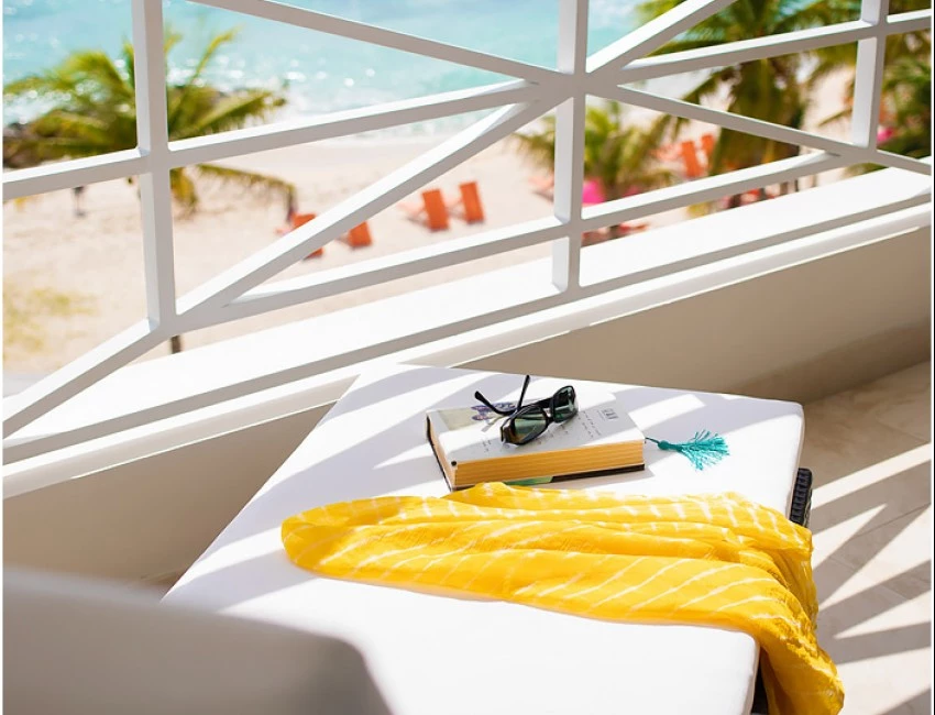lounger on a balcony overlooking the beach