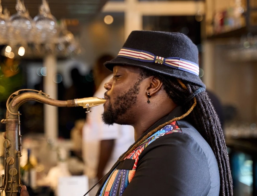 a man with a beard and a hat playing a musical instrument
